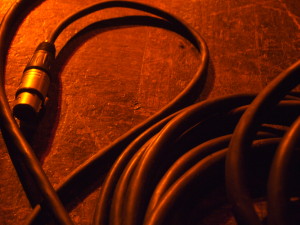 red-lit XLR audio cable on floor